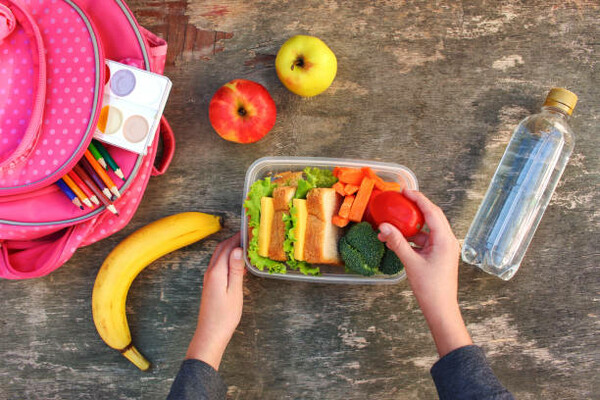 a student lunchbox containing healthy fruits and vegetables