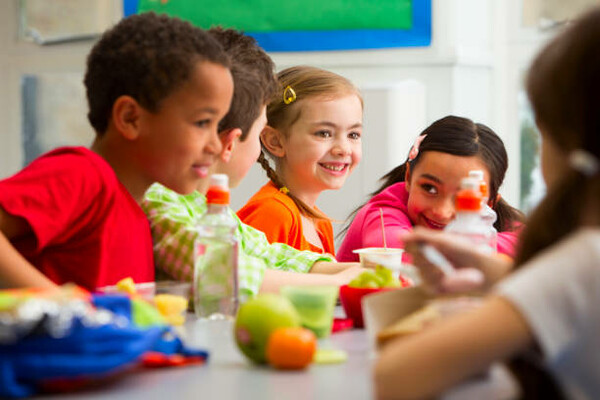 Students at a table eating lunch